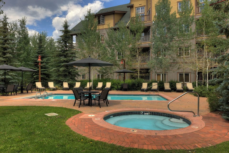 Relax by the heated pool and hot tub, surrounded by mountain scenery and lush evergreens. Lounge on the sundeck or unwind under shaded seating—your perfect alpine retreat awaits.