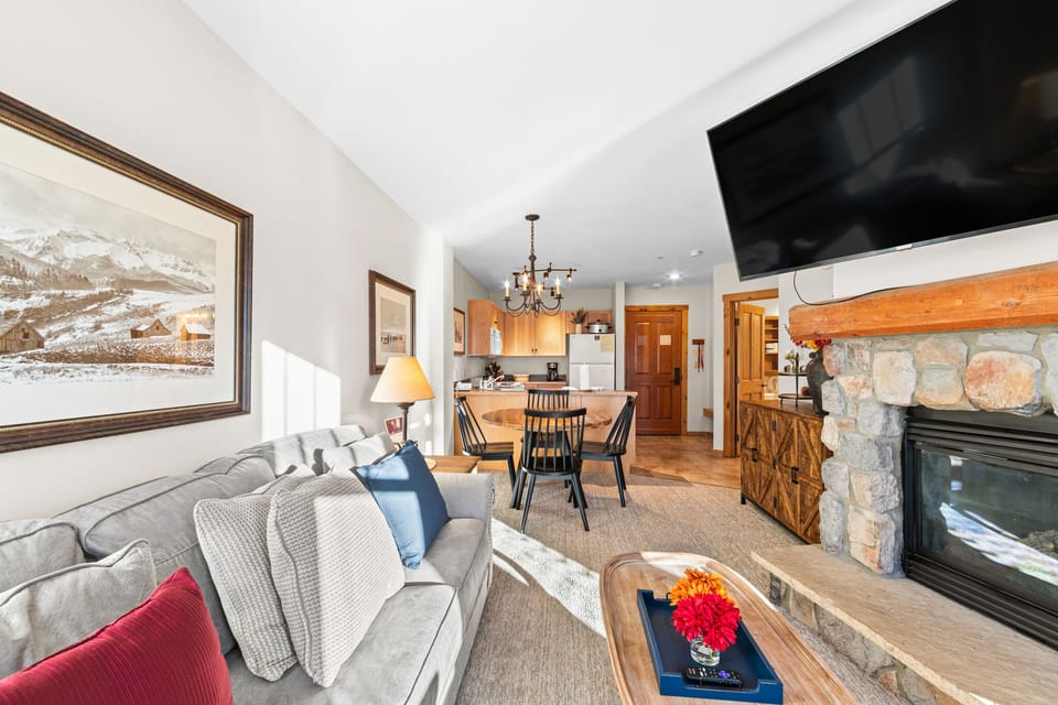 Sink into the plush sofa by your stone fireplace while your favorite show plays overhead. The open layout flows beautifully from living room to dining and kitchen.