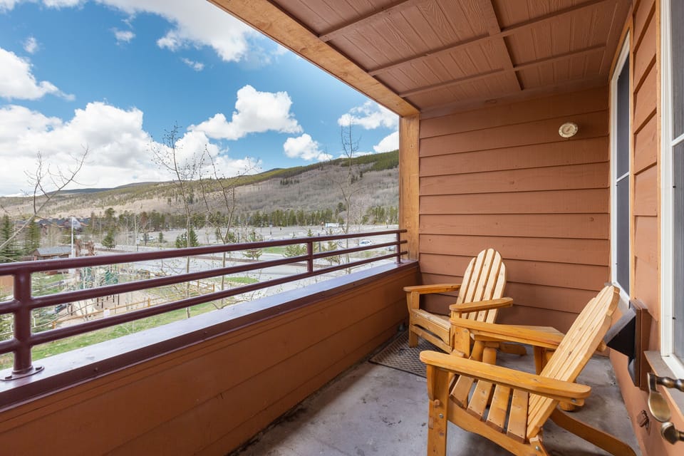 Sink into comfortable wooden chairs on your private balcony and soak up breathtaking mountain views in crisp, refreshing air.