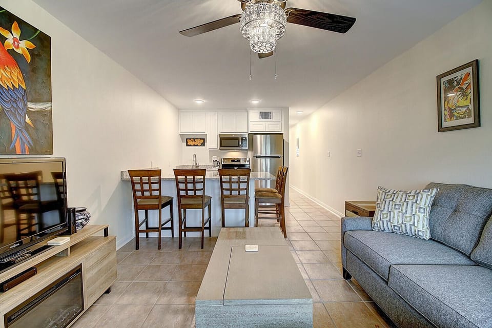 Relax in your bright, modern living space with a fully equipped kitchen and comfortable seating for memorable vacation moments.