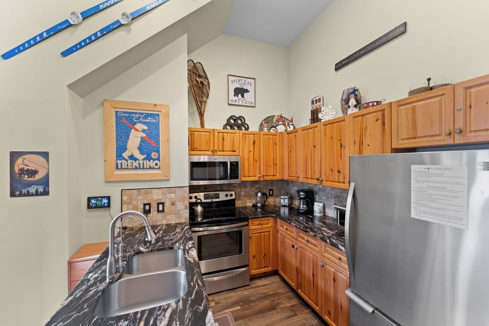 Your fully equipped kitchen features modern appliances and rustic charm, perfect for preparing meals after mountain adventures.