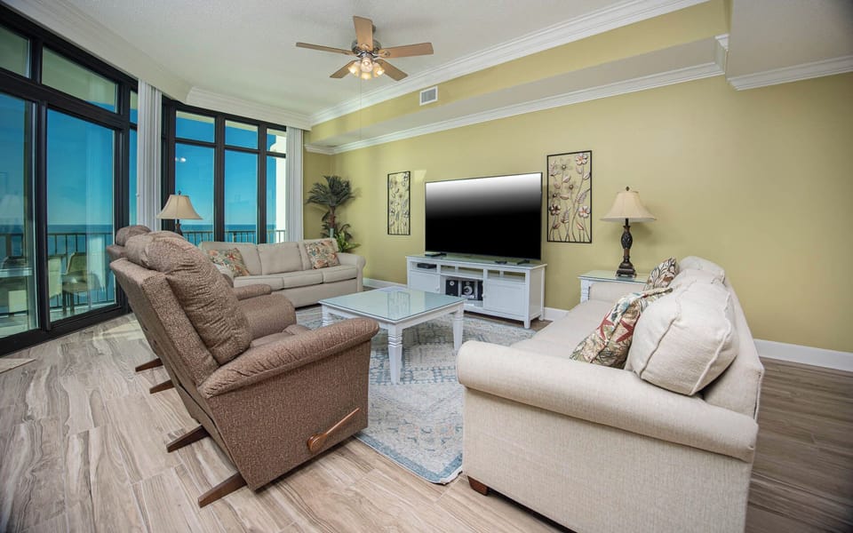 Relax on a plush sofa with queen sleeper as you enjoy a movie, surrounded by coastal views and soothing decor