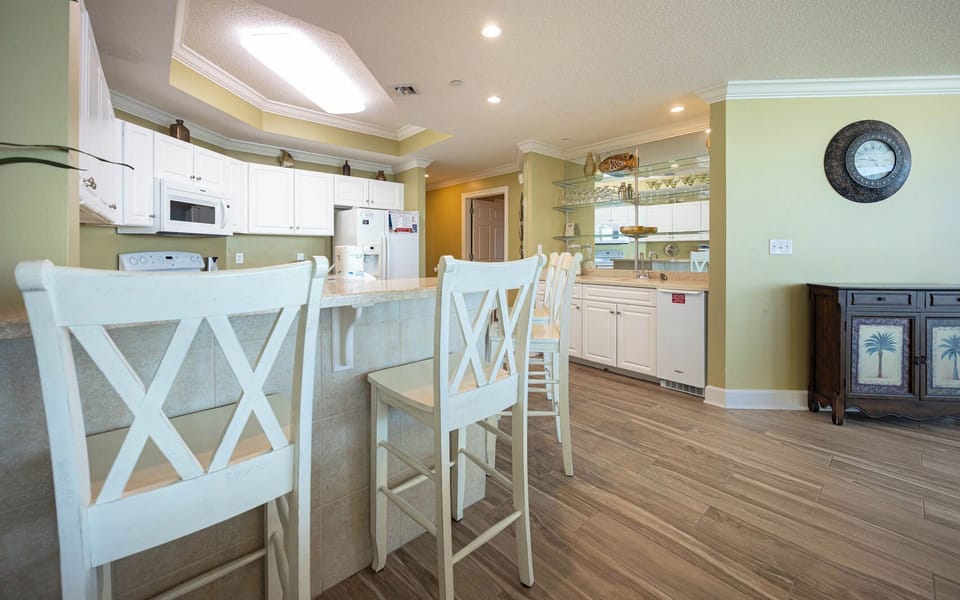 Gather for fun conversations at the breakfast bar, surrounded by cheerful decor and a warm vibe