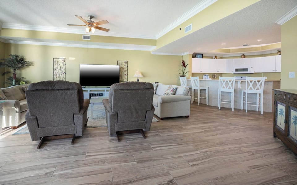 Unwind in cozy chairs as you enjoy movies together, soaking in the beach vibe from your inviting living space