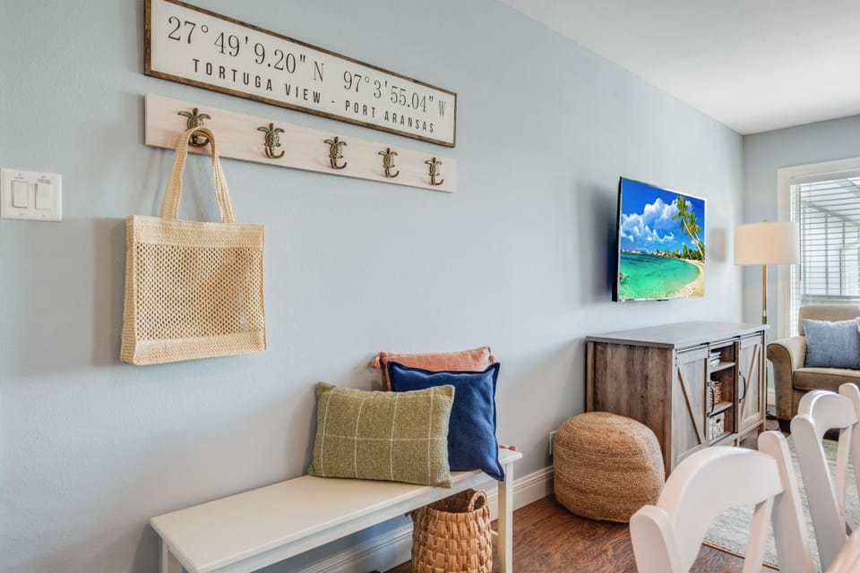 Settle into this charming coastal-themed living space where thoughtful touches and comfortable seating create your perfect relaxation zone.