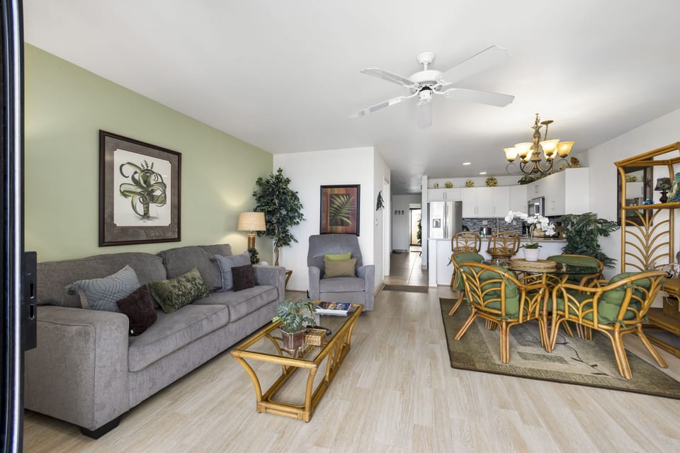 Relax in your open-concept living space, where soft greens and natural light create a warm, welcoming atmosphere. Gather around the dining table, unwind on the couch, and enjoy every moment of your stay.