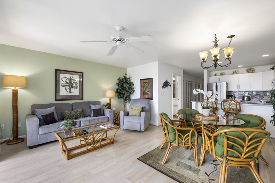 Picture yourself relaxing in this bright, open living and dining space with tropical accents, cozy seating, and a fully-equipped kitchen where your vacation memories begin.