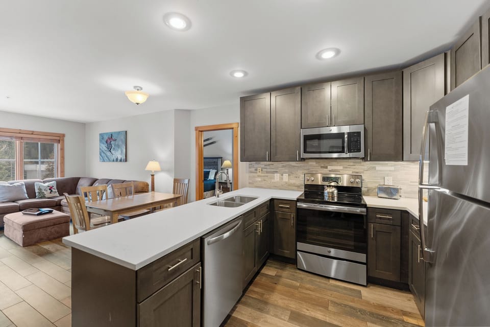 Your modern kitchen flows seamlessly into the cozy living area, perfect for preparing meals while staying connected with your group.