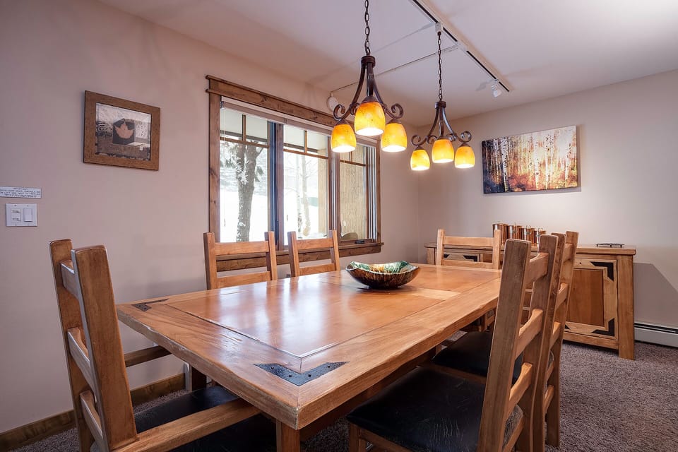 Gather around this handcrafted wooden dining table where your group can share meals and create memories together.