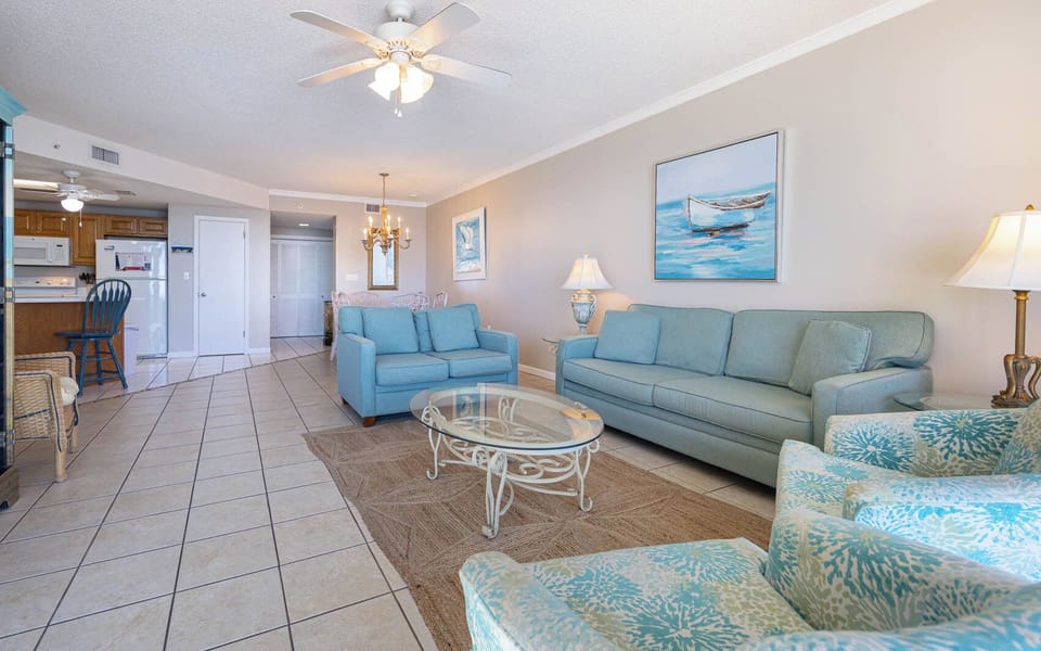 Unwind in the comfortable living area with soft seating, sofa with queen sleeper, stylish coffee table, and coastal decor