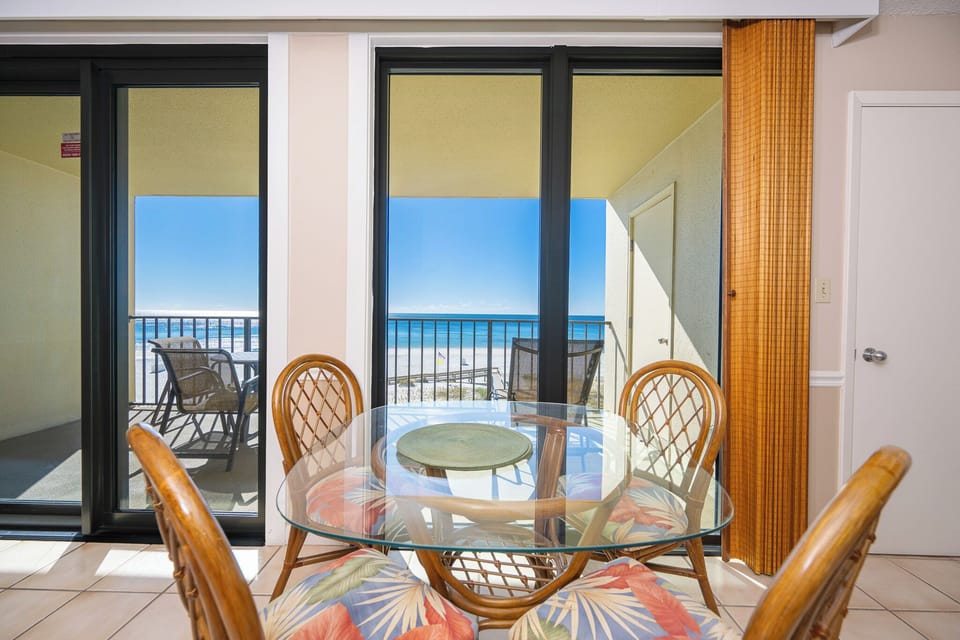 Gather around the glass-top table while enjoying beautiful coastal views and the welcoming beach vibe