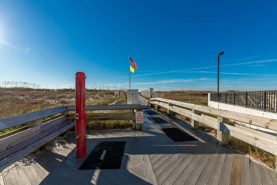 Step onto the boardwalk leading to the beach, complete with a shower for rinding off and daily beach flag updates