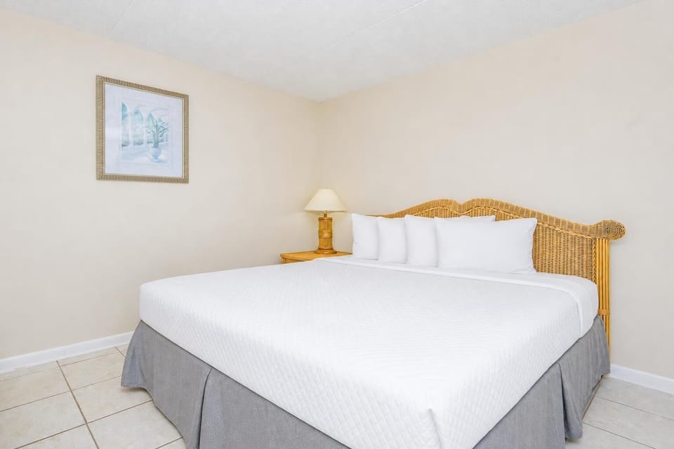 Guest room with a plush queen bed with crisp linens, perfect for a restful night's sleep