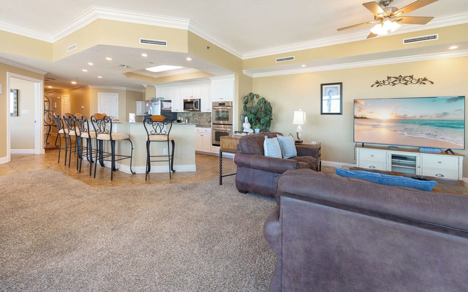 Gather in this welcoming living space and enjoy stunning panoramic beach views through the windows