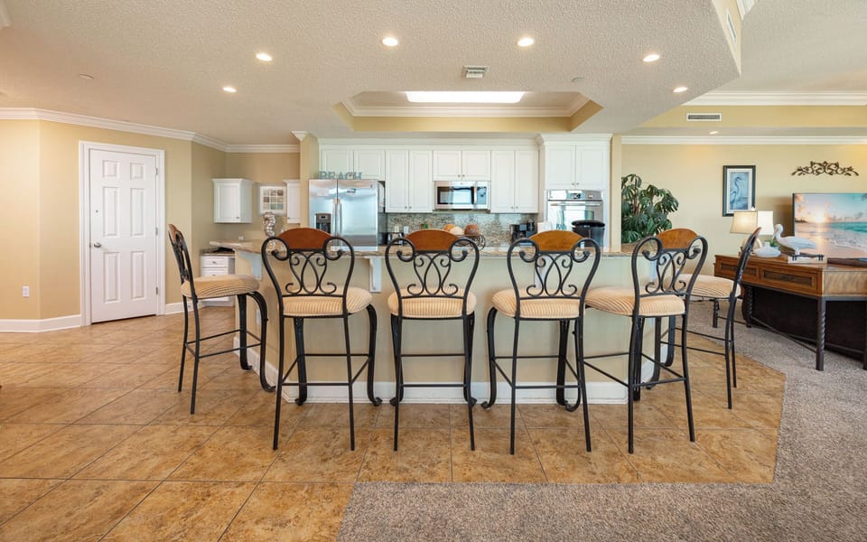 Sip your morning coffee at the breakfast bar and get ready for a beach day in this stylish space