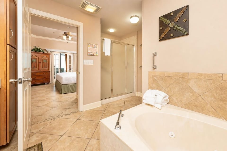 The master bath offers a soaking tub and separate shower where you unwind after a day along the gulf coast
