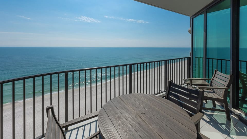 Rest on your balcony chairs and watch the sunlight dance on the endless blue coast below