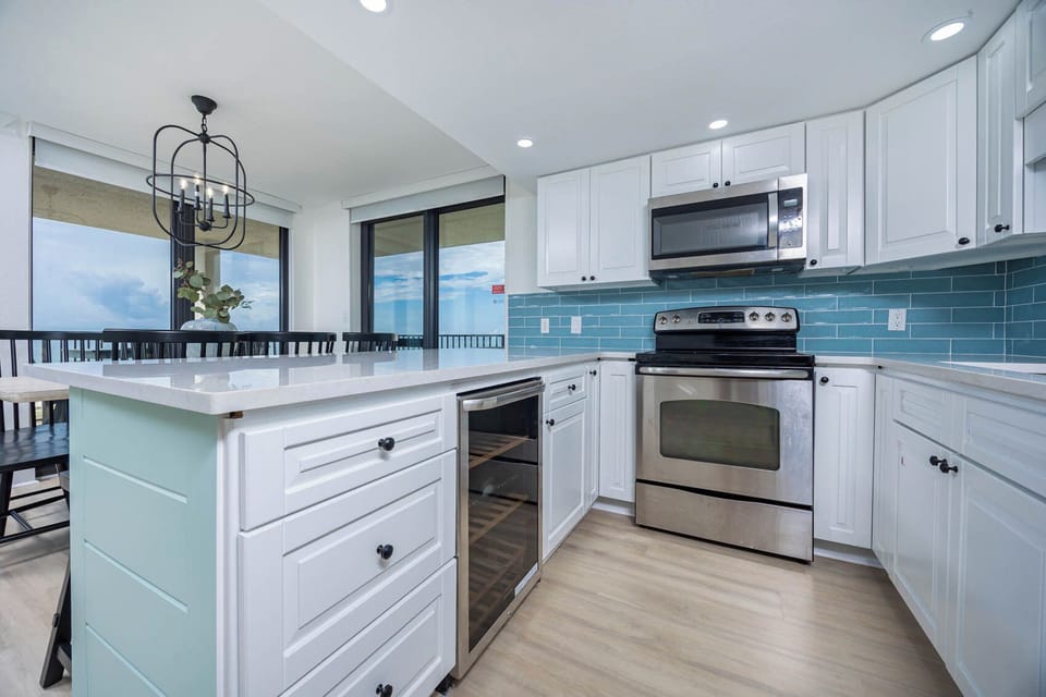 Bright kitchen opens to a dining area where you enjoy peaceful glances over the shimmering shore beyond glass doors