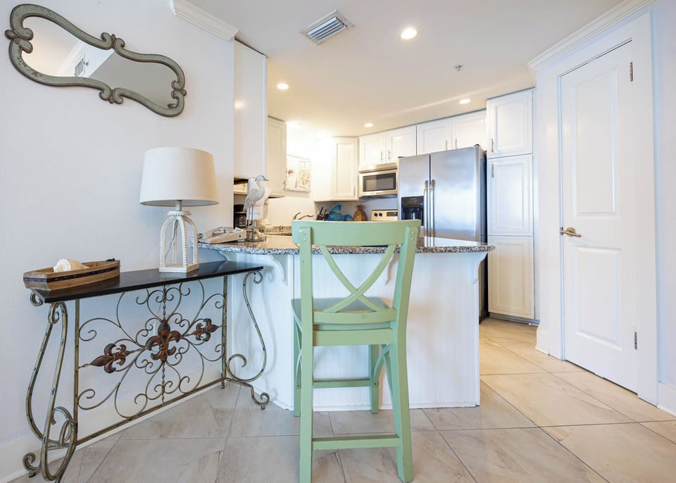 Spacious kitchen and breakfast bar area with stainless appliances, perfect for enjoying meals and conversation