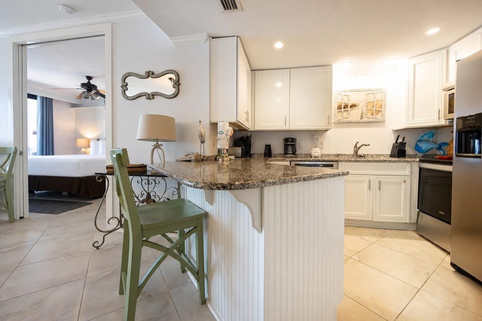 Enjoy cooking and dining at the granite countertop, with a cozy view into the inviting living area and master suite