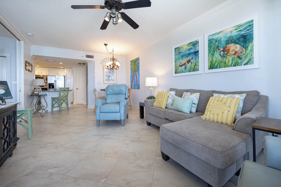 Relax in the inviting living area with comfortable seating, vibrant coastal decor, and a vibe that enhances your stay