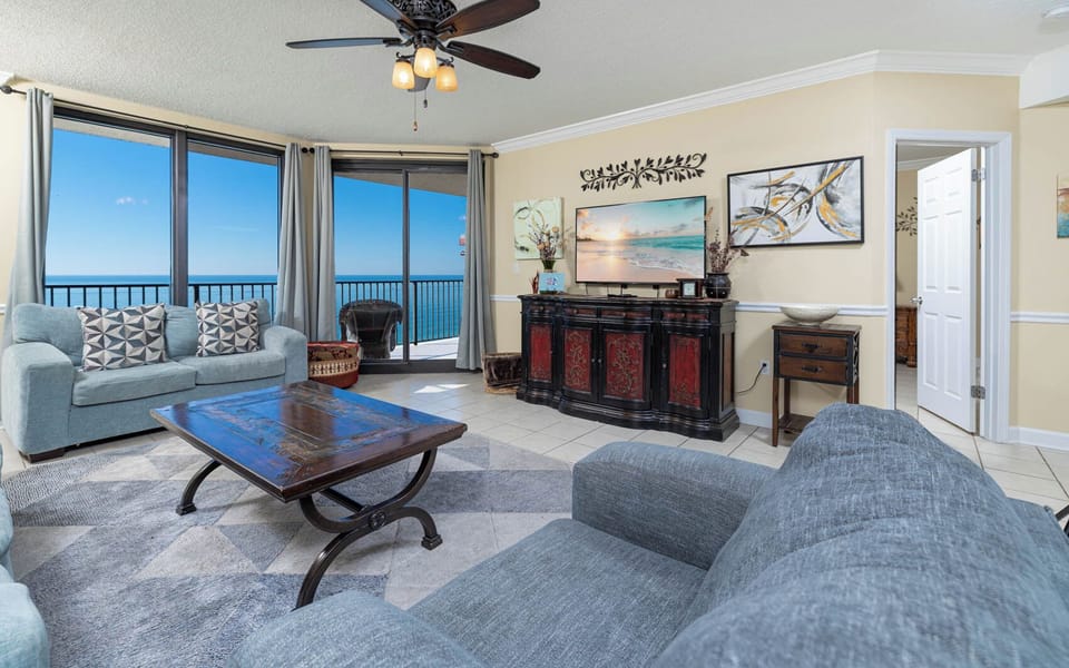 Relax in the airy living room with a sofa with queen sleeper, a beautiful view, and a large TV for your entertainment
