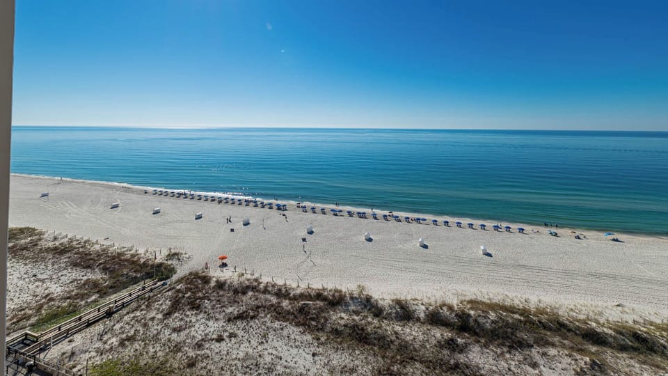 Enjoy the serene view from your balcony, overlooking the beach and calm waters, perfect for relaxation and tranquility