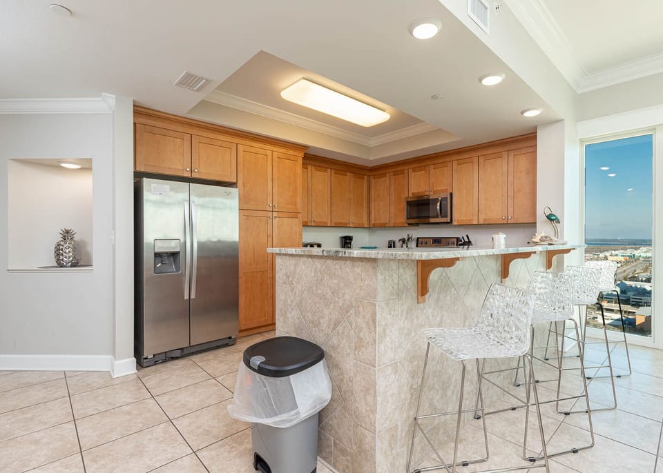 Cook and gather in this spacious kitchen with stainless appliances, a breakfast bar, and stunning beach views