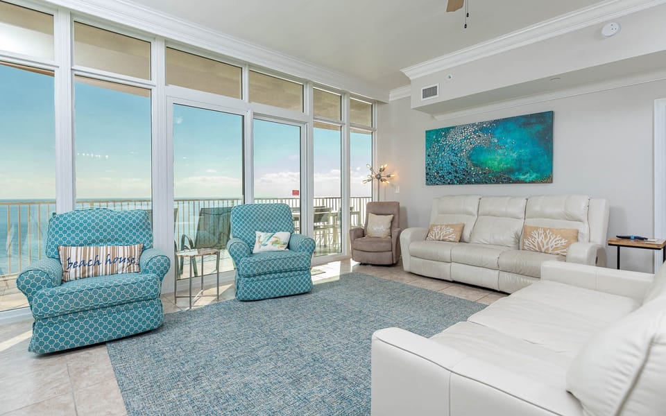 Relax in this inviting living area with plush seating, queen sofa sleeper, vibrant decor, and stunning views