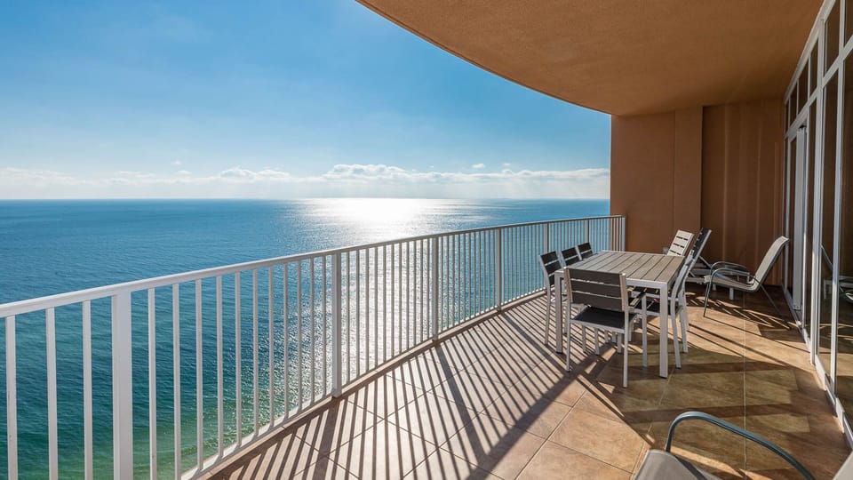Enjoy meals or morning coffee on the spacious balcony, offering expansive beachfront views