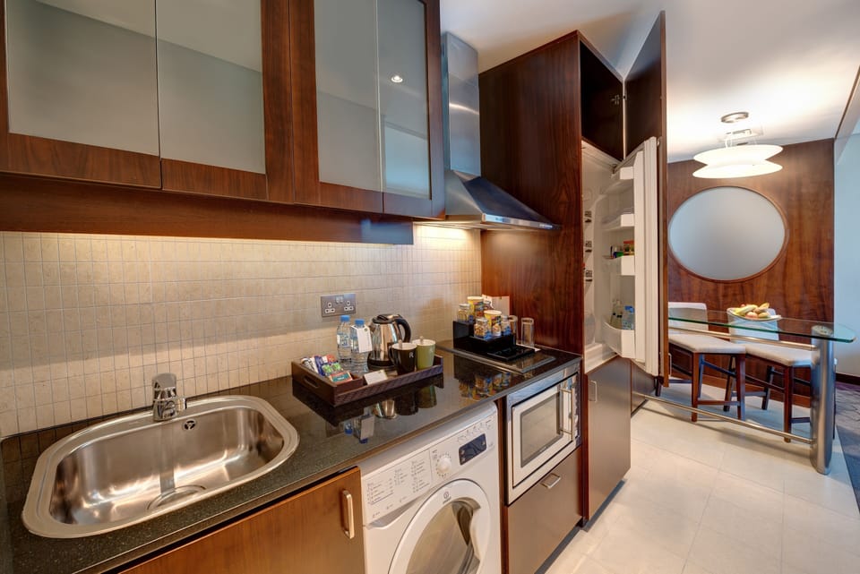 Full-size fridge, microwave, electric kettle, cookware/dishes/utensils