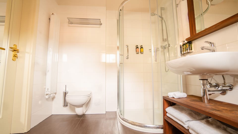 Combined shower/tub, designer toiletries, hair dryer, bathrobes