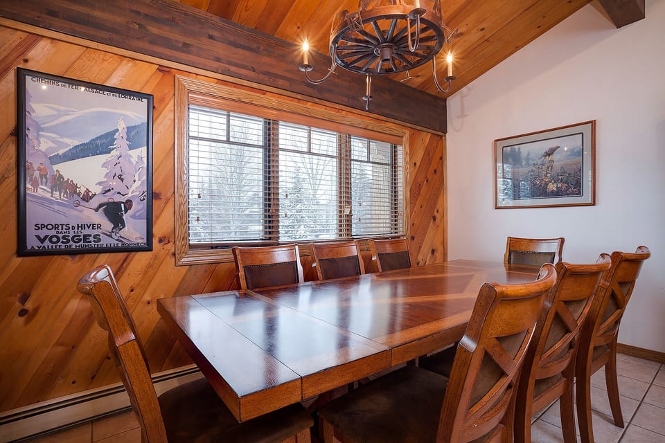 Your rustic dining room features a handcrafted wooden table beneath exposed beams, perfect for sharing memorable meals with family and friends.