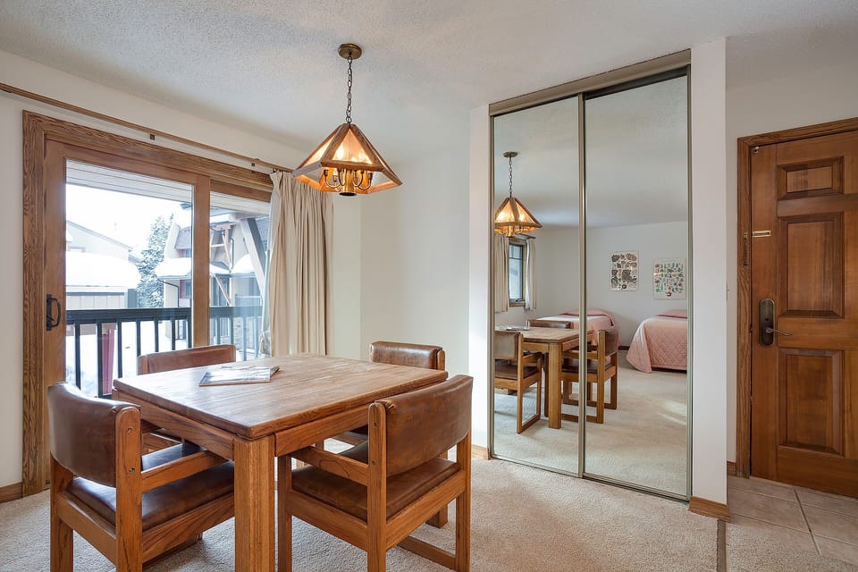 Gather around this inviting dining table where warm wood tones and mountain lodge charm create perfect moments for your meals together.