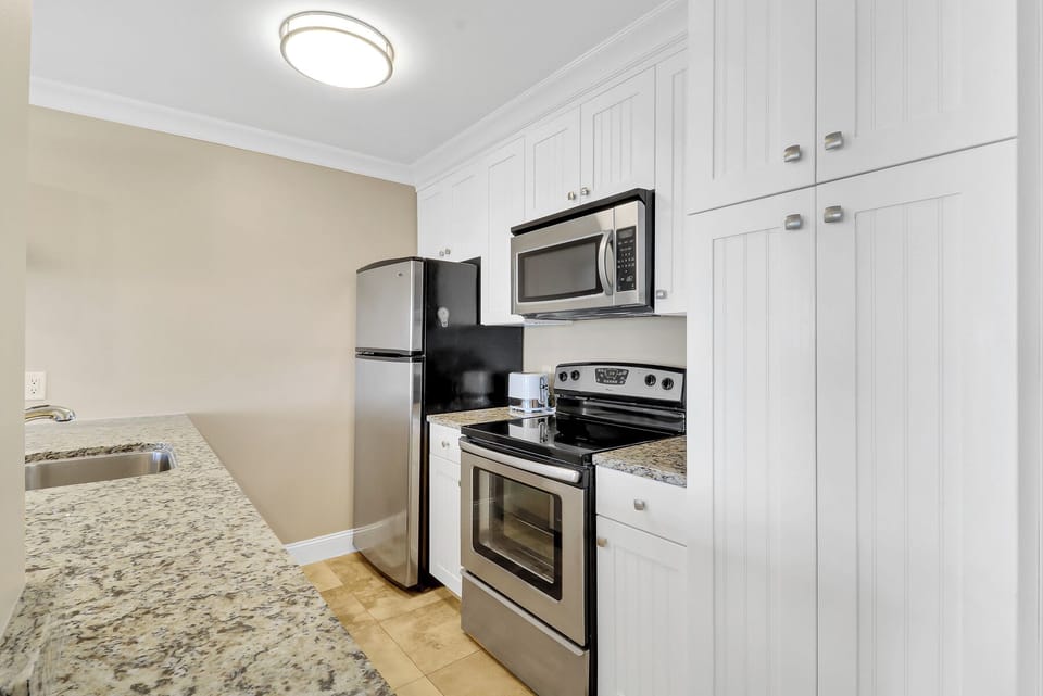 Kitchen - Sleek, fully equipped kitchen with modern appliances and ample cabinet space.