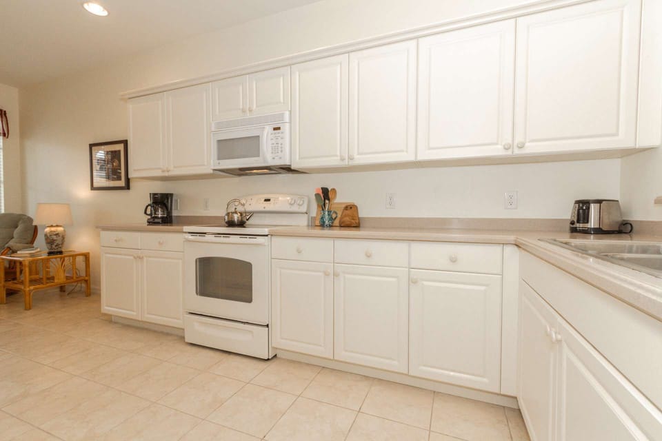 The kitchen features expansive cabinets and counter space, and comes with all the items you should need for your vacation meal prep and serving.