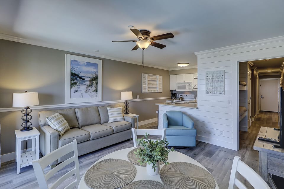 Living area - This unit has been totally renovated.  All new flooring, furniture, shiplap wall surfaces.  Queen sized sleeper sofa for extra guests!    Great place to relax at the ocean.