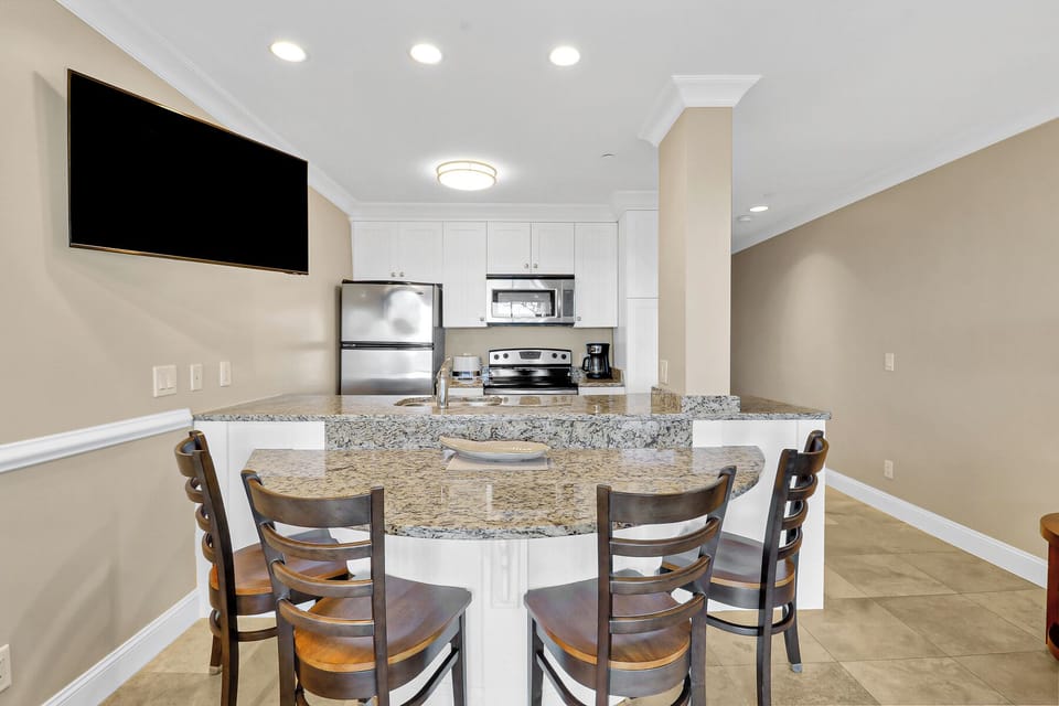 Kitchen - “A bright, updated kitchen with modern finishes and a spacious dining area, perfect for meals after a day at the beach.”