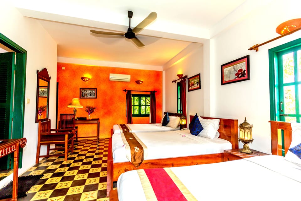 Deluxe Triple Room, 1 Bedroom, Garden View, Garden Area | Free minibar items, in-room safe, soundproofing, iron/ironing board