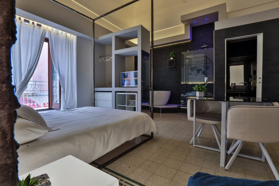 Junior Suite, Balcony, Sea View | Minibar, in-room safe, desk, iron/ironing board