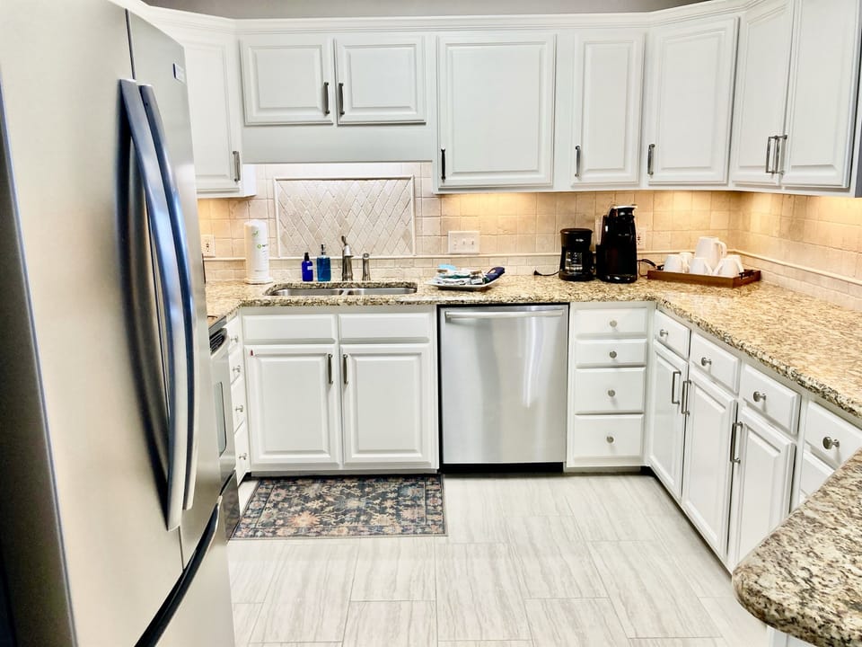 This fully stocked kitchen features stainless appliances and granite countertops!