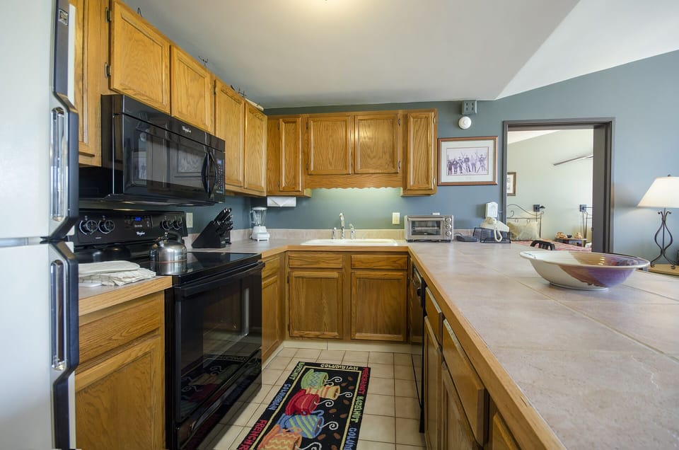 Your fully equipped kitchen features warm oak cabinetry and everything you need to prepare memorable meals during your stay.