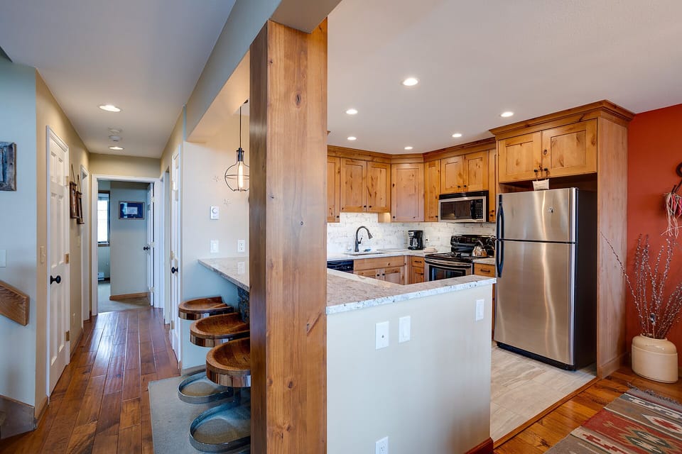 Your fully equipped kitchen features warm wood cabinetry, granite counters, and stainless appliances for memorable meal prep.