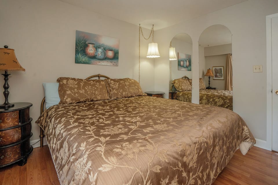 Picture yourself unwinding in this peaceful bedroom, where elegant décor and soft lighting create a restful retreat. The plush bedding and tasteful touches invite you to relax after a day of adventure.
