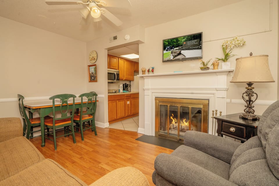 Unwind in your cozy living space where a crackling fireplace and comfortable seating invite you to relax after a day of exploring the Smokies.
