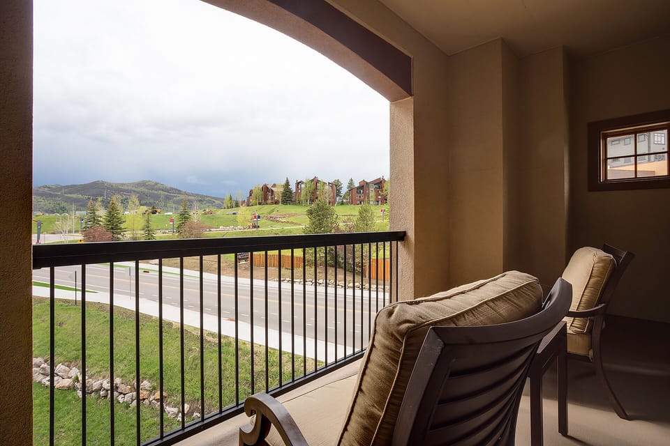 Settle into your private balcony chairs and soak in sweeping mountain views across rolling green landscapes.
