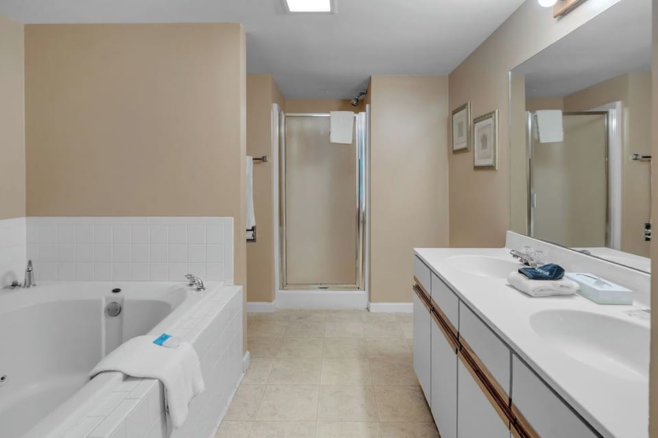 Main bath with a large jetted tub and separate shower.