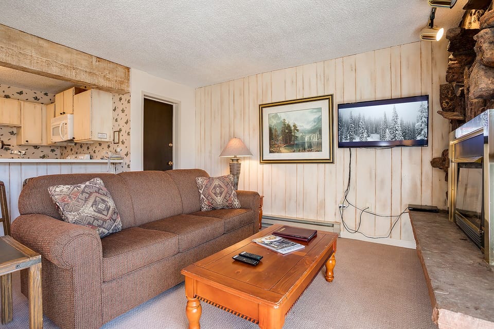 Cozy up in your mountain retreat with rustic charm, complete with stone fireplace and flat-screen TV for perfect après-ski evenings.