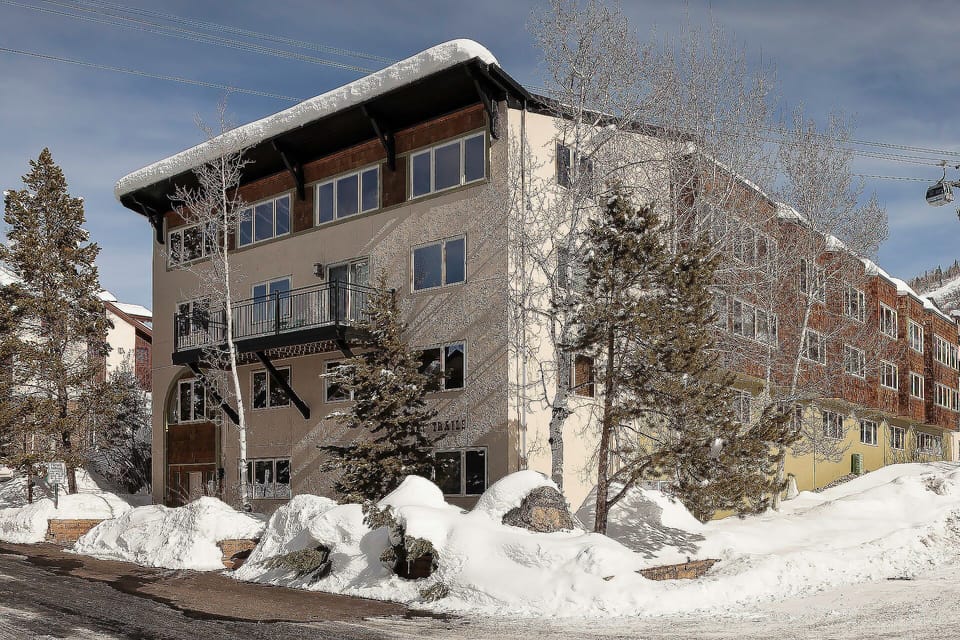 A charming alpine building surrounded by pristine snow and mountain scenery, creating the perfect winter retreat atmosphere.