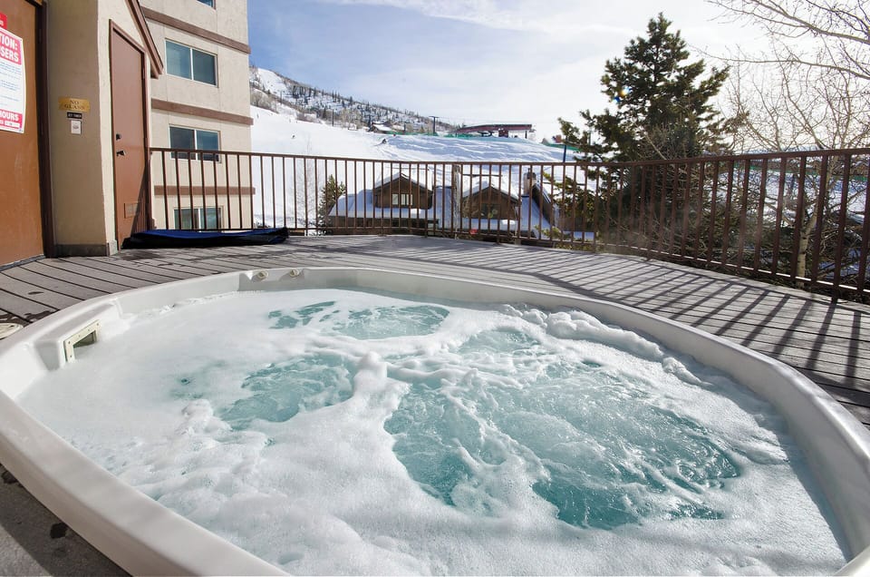Soak in the bubbling hot tub on your private deck while gazing at snow-dusted mountain slopes—a perfect way to unwind after a day of adventure.